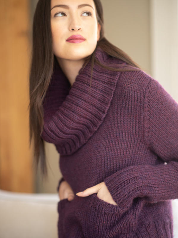 Free knitting pattern for a cozy sweater with a knit in pieces from the bottom up, featuring a small front pockets and a deep ribbed cowlneck